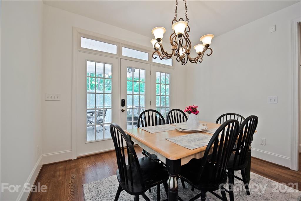 145 Huntington Ridge Place Mooresville, NC 28115 - Photo 22 of 45 a view of a dining room with furniture a chandelier and wooden floor