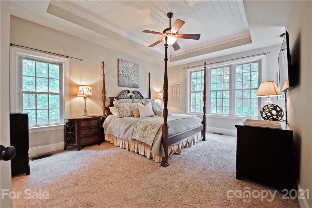 145 Huntington Ridge Place Mooresville, NC 28115 - Photo 23 of 45 a spacious bedroom with a bed and a chandelier