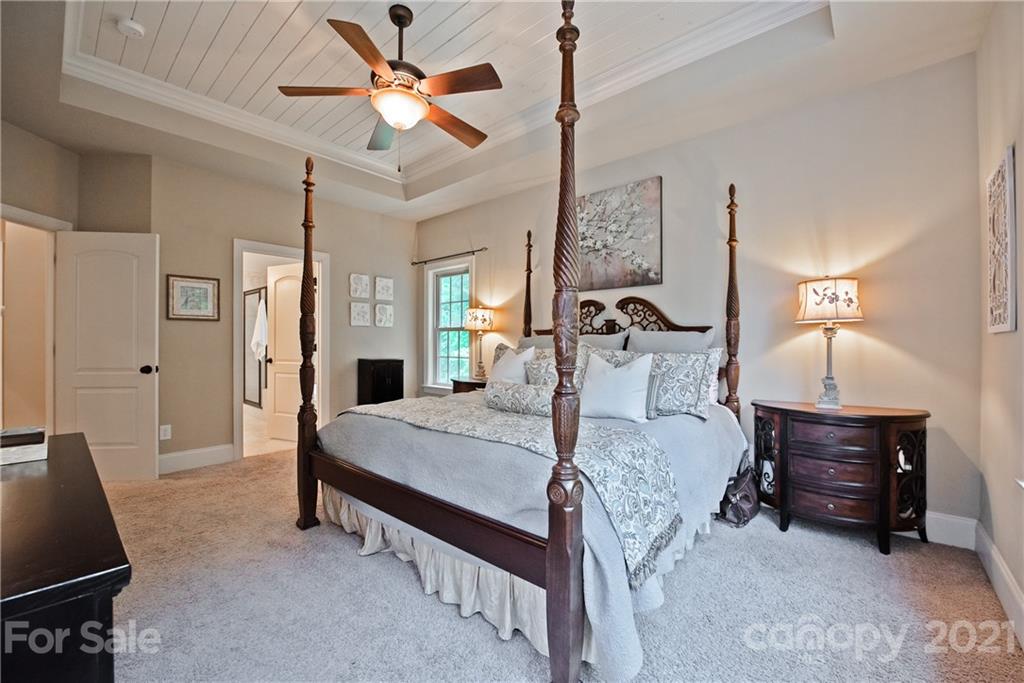 145 Huntington Ridge Place Mooresville, NC 28115 - Photo 24 of 45 a bed room with a bed and a chandelier