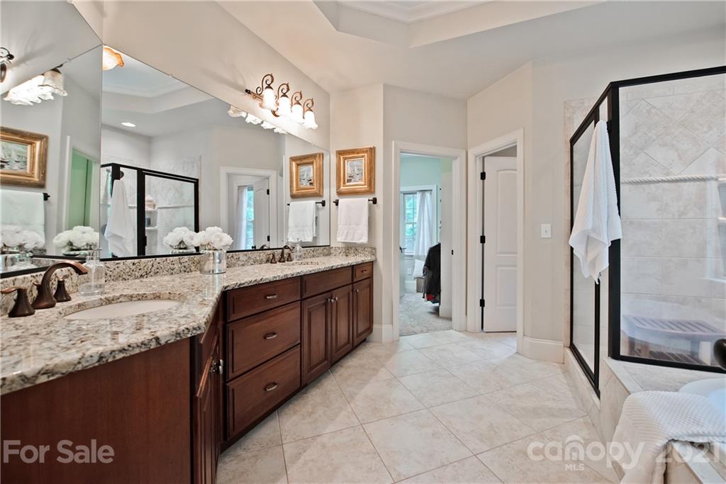 145 Huntington Ridge Place Mooresville, NC 28115 - Photo 25 of 45 a spacious bathroom with a granite countertop sink a mirror and a shower