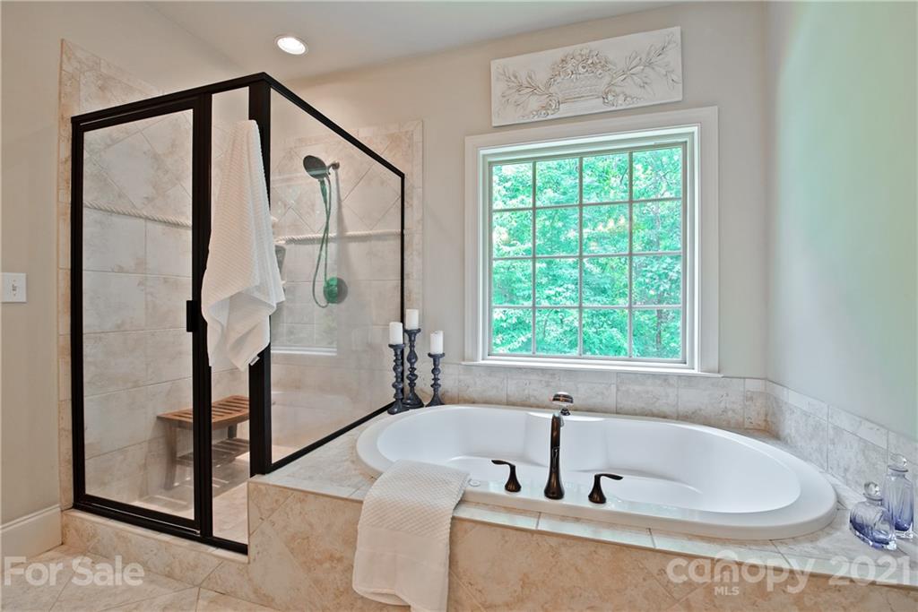 145 Huntington Ridge Place Mooresville, NC 28115 - Photo 26 of 45 a bathroom with a tub and shower