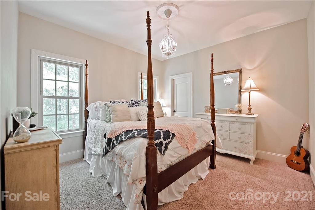 145 Huntington Ridge Place Mooresville, NC 28115 - Photo 28 of 45 a bed room with a bed and a chair