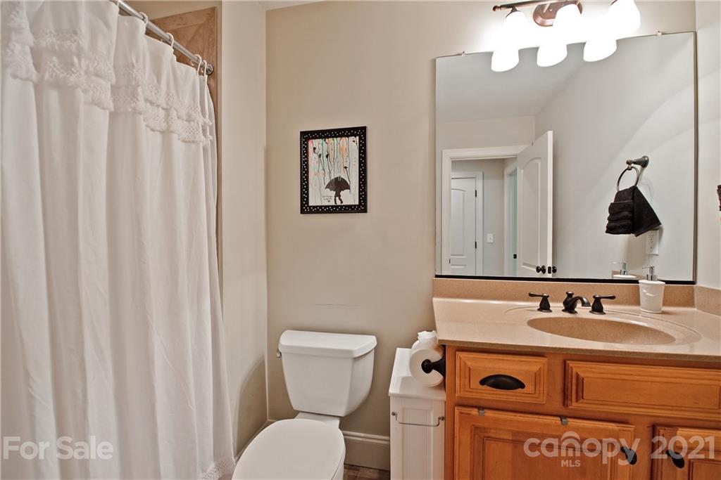 145 Huntington Ridge Place Mooresville, NC 28115 - Photo 32 of 45 a bathroom with a sink a toilet and a mirror