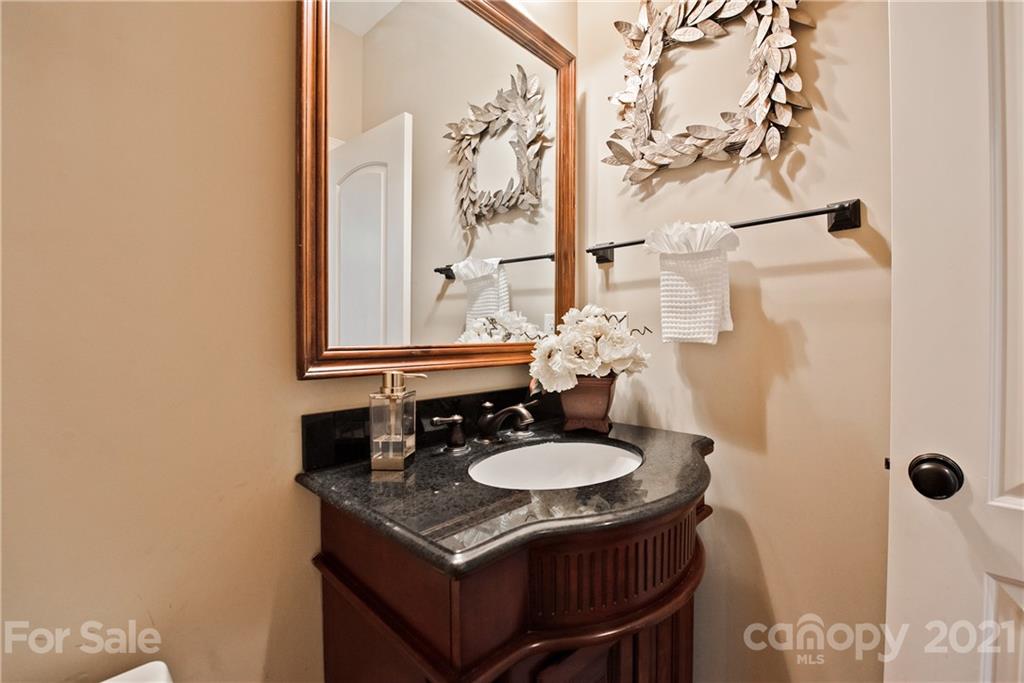 145 Huntington Ridge Place Mooresville, NC 28115 - Photo 35 of 45 a bathroom with a sink and a mirror