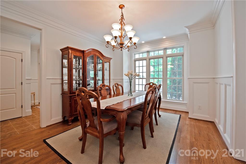145 Huntington Ridge Place Mooresville, NC 28115 - Photo 7 of 45 a view of a dining room with furniture a chandelier and wooden floor