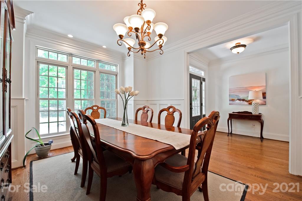 145 Huntington Ridge Place Mooresville, NC 28115 - Photo 8 of 45 a view of a dining room with furniture a chandelier and wooden floor