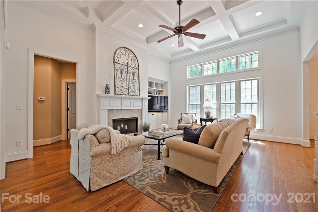 145 Huntington Ridge Place Mooresville, NC 28115 - Photo 10 of 45 a living room with furniture a fireplace and a large window