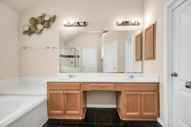 a bathroom with a sink vanity and a mirror