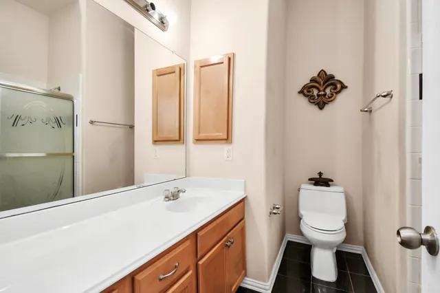 a bathroom with a toilet sink and mirror