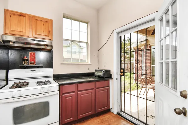 a kitchen with a stove a sink and a microwave