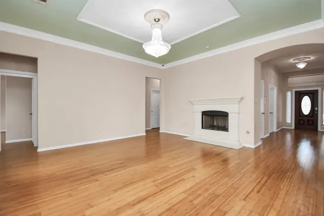 a view of a livingroom with wooden floor and a fireplace