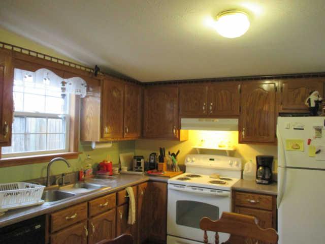 995 Rose Hill Road Pulaski, TN 38478 - Photo 5 of 20 a kitchen with a sink a stove cabinets and a window