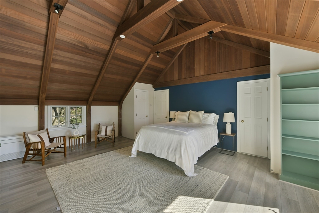 17 Laurel Road Brookline, MA 02467 - Photo 13 of 29 a bedroom with a bed a table and chairs