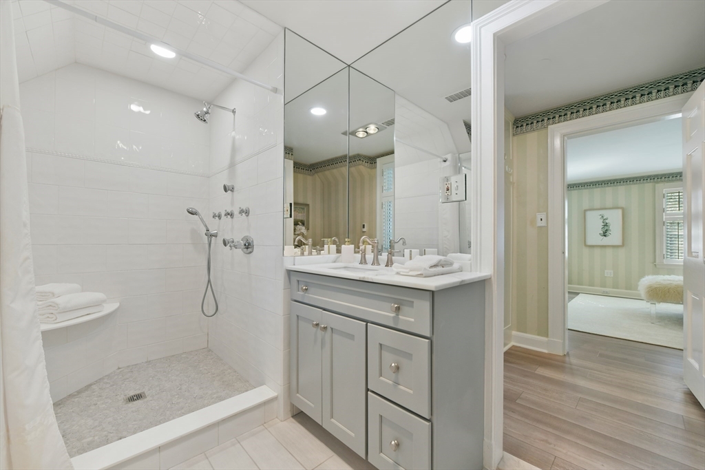 17 Laurel Road Brookline, MA 02467 - Photo 18 of 29 a bathroom with a shower sink and mirror