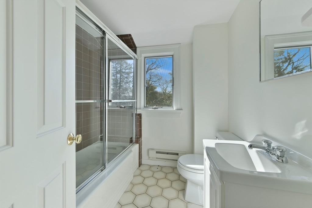 17 Laurel Road Brookline, MA 02467 - Photo 21 of 29 a bathroom with a toilet a sink and shower