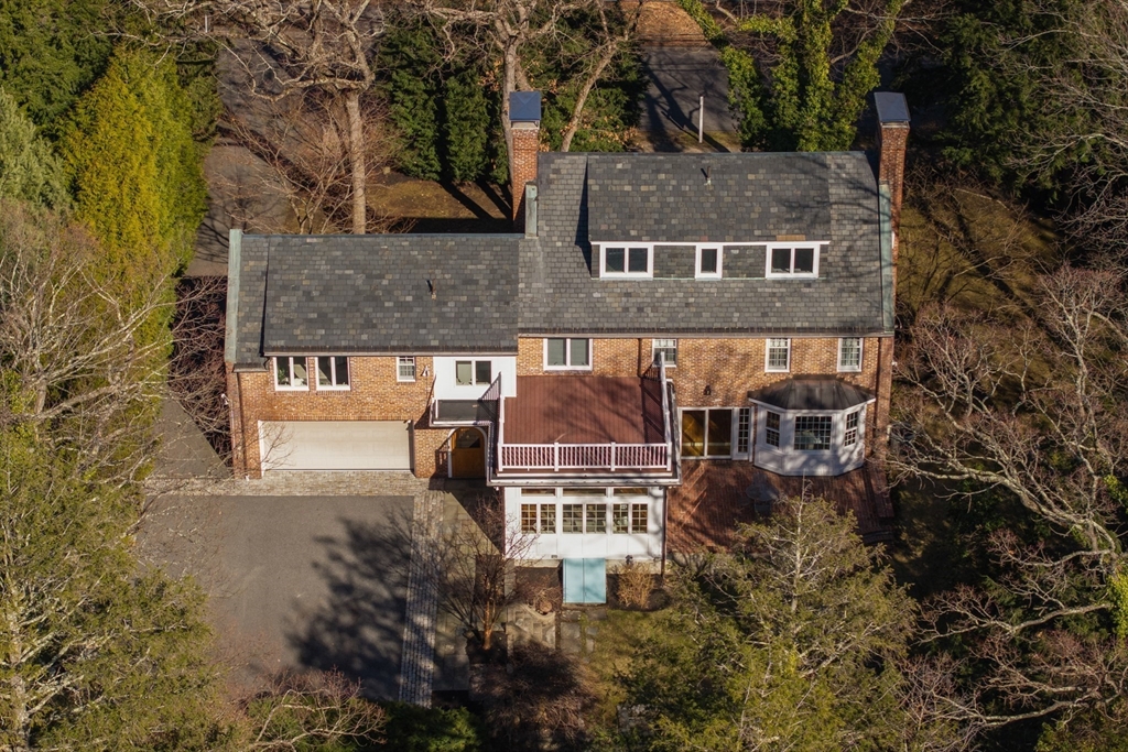 17 Laurel Road Brookline, MA 02467 - Photo 23 of 29 a front view of a house with a yard and garage