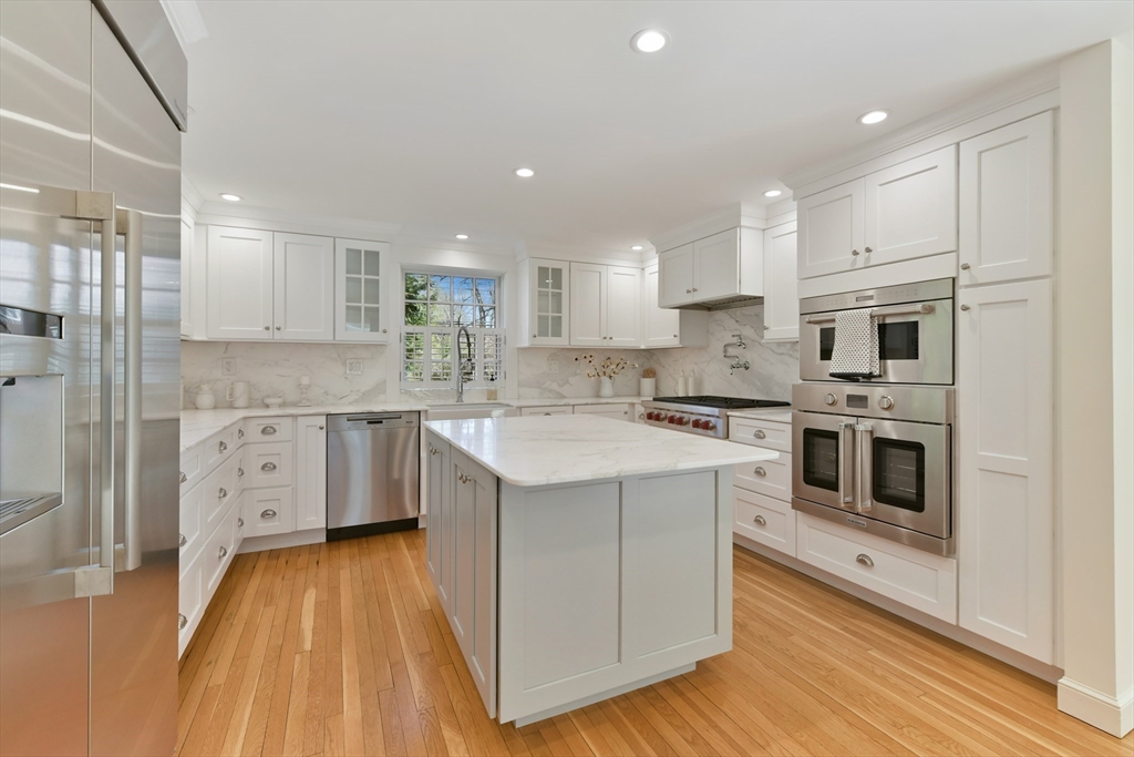 17 Laurel Road Brookline, MA 02467 - Photo 7 of 29 a kitchen with stainless steel appliances granite countertop a white stove top oven and cabinets