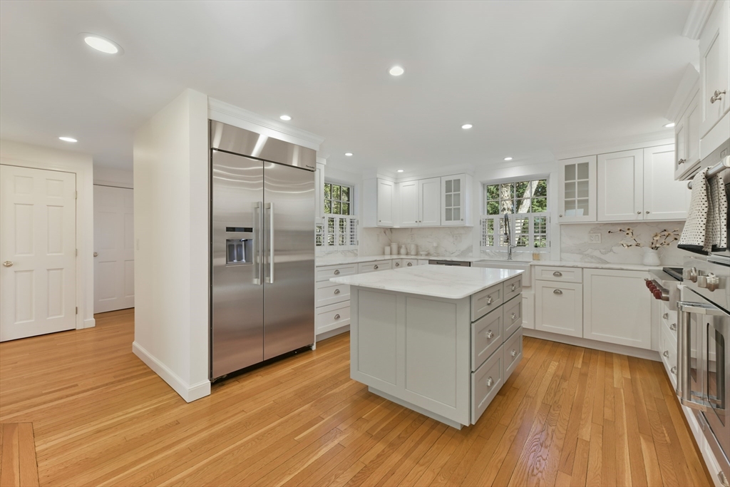 17 Laurel Road Brookline, MA 02467 - Photo 8 of 29 a kitchen with a white wooden floors a kitchen island and stainless steel appliances