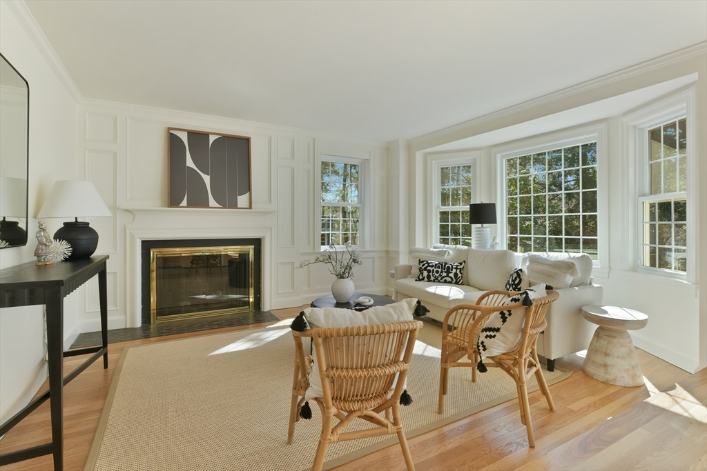 17 Laurel Road Brookline, MA 02467 - Photo 10 of 29 a dining room with furniture and a fireplace