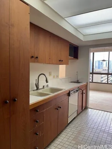 a kitchen with stainless steel appliances granite countertop a sink a stove and cabinets