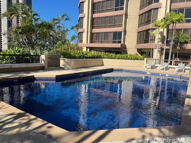 a view of a swimming pool with a bench