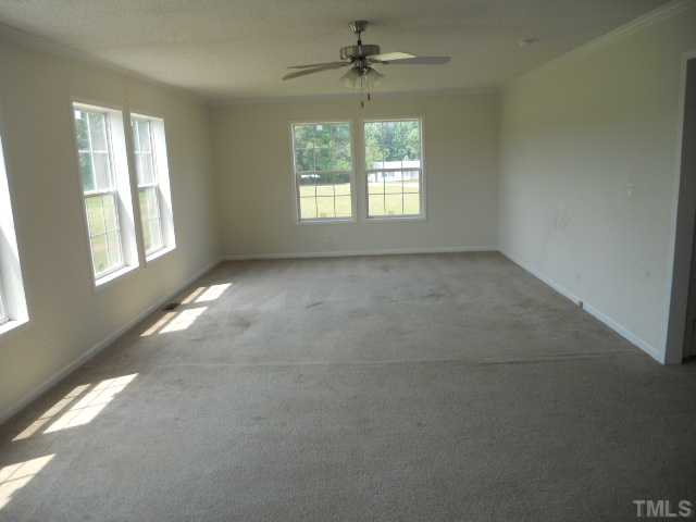 13061 Edwards Road Spring Hope, NC 27882 - Photo 12 of 12 en empty room with windows and chandelier fan