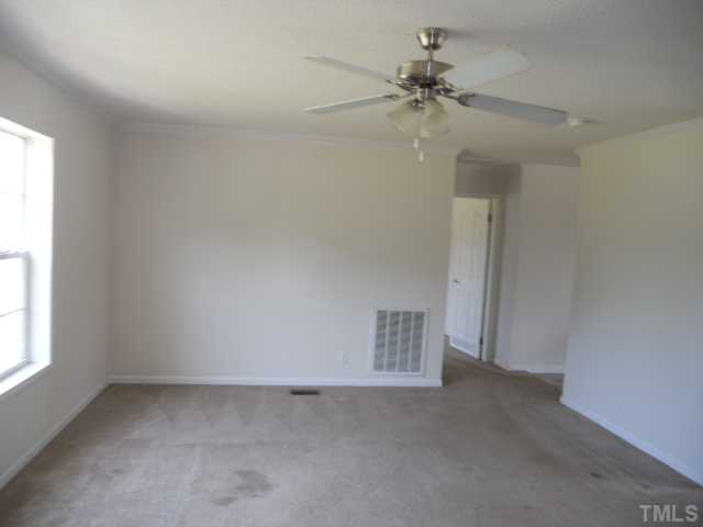 13061 Edwards Road Spring Hope, NC 27882 - Photo 3 of 12 an empty room with a window and a fan