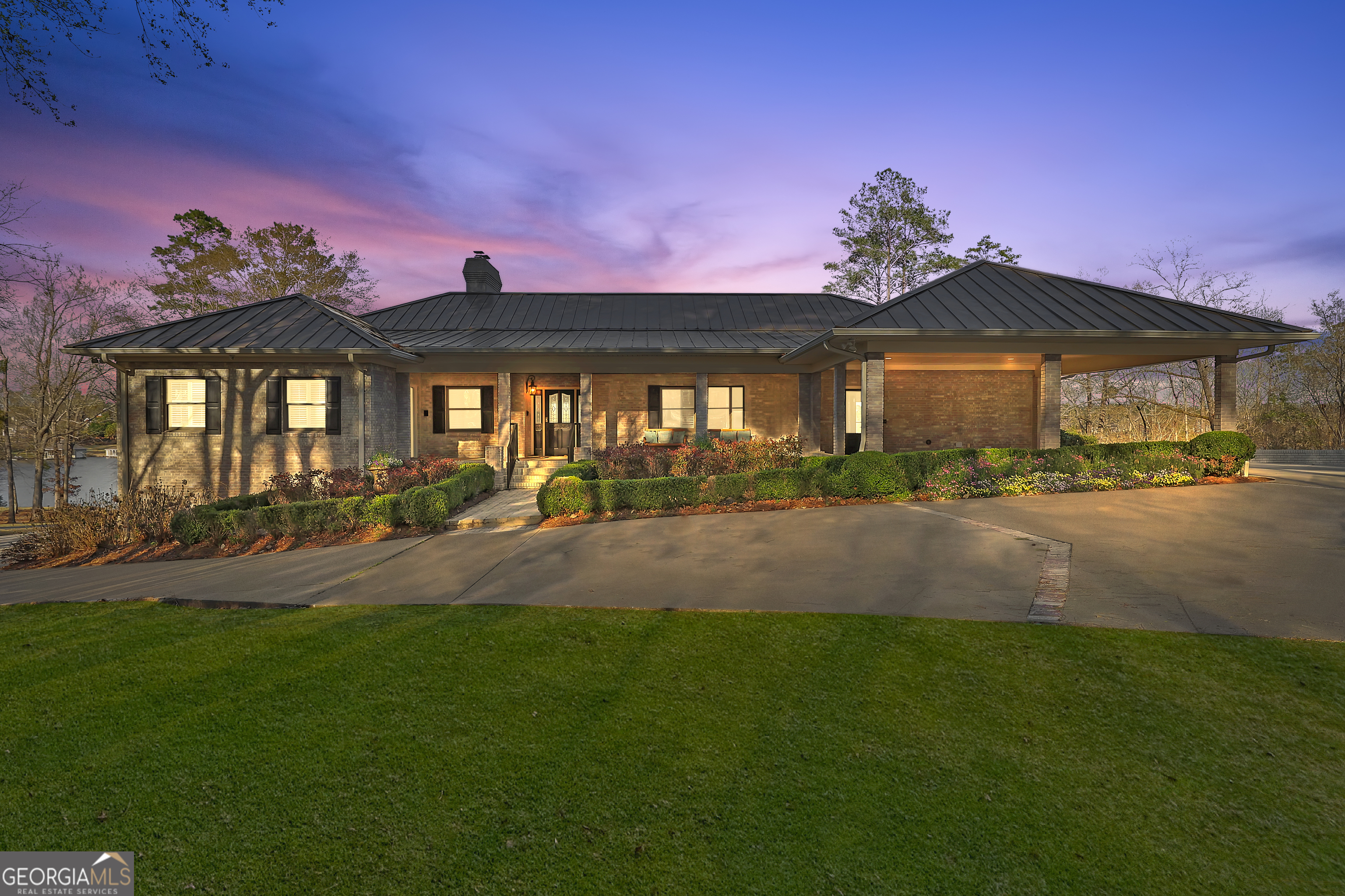 a front view of a house with a yard and outdoor seating
