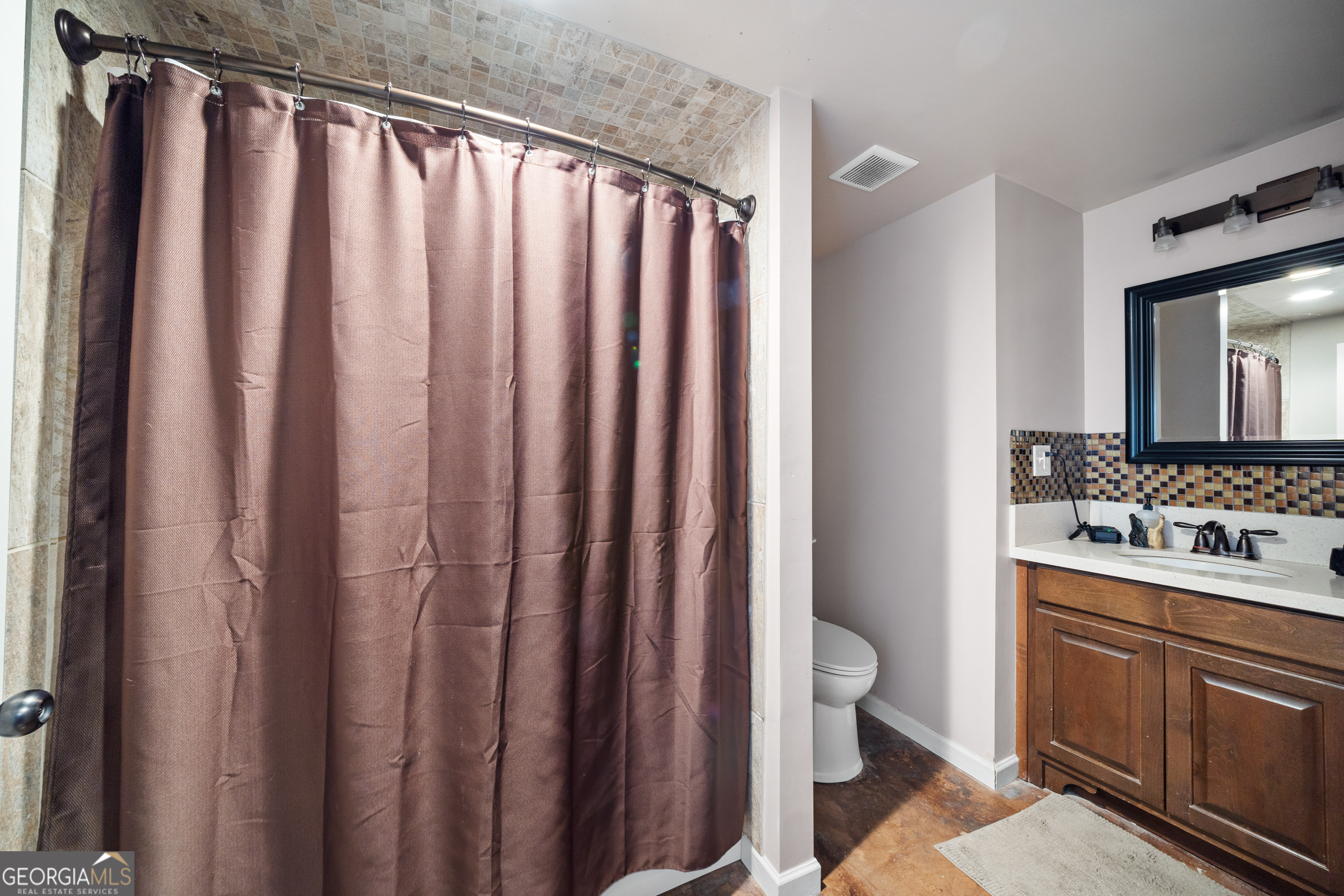 121 Grace Trace Lizella, GA 31052 - Photo 157 of 197 a bathroom with a sink a toilet and shower curtain