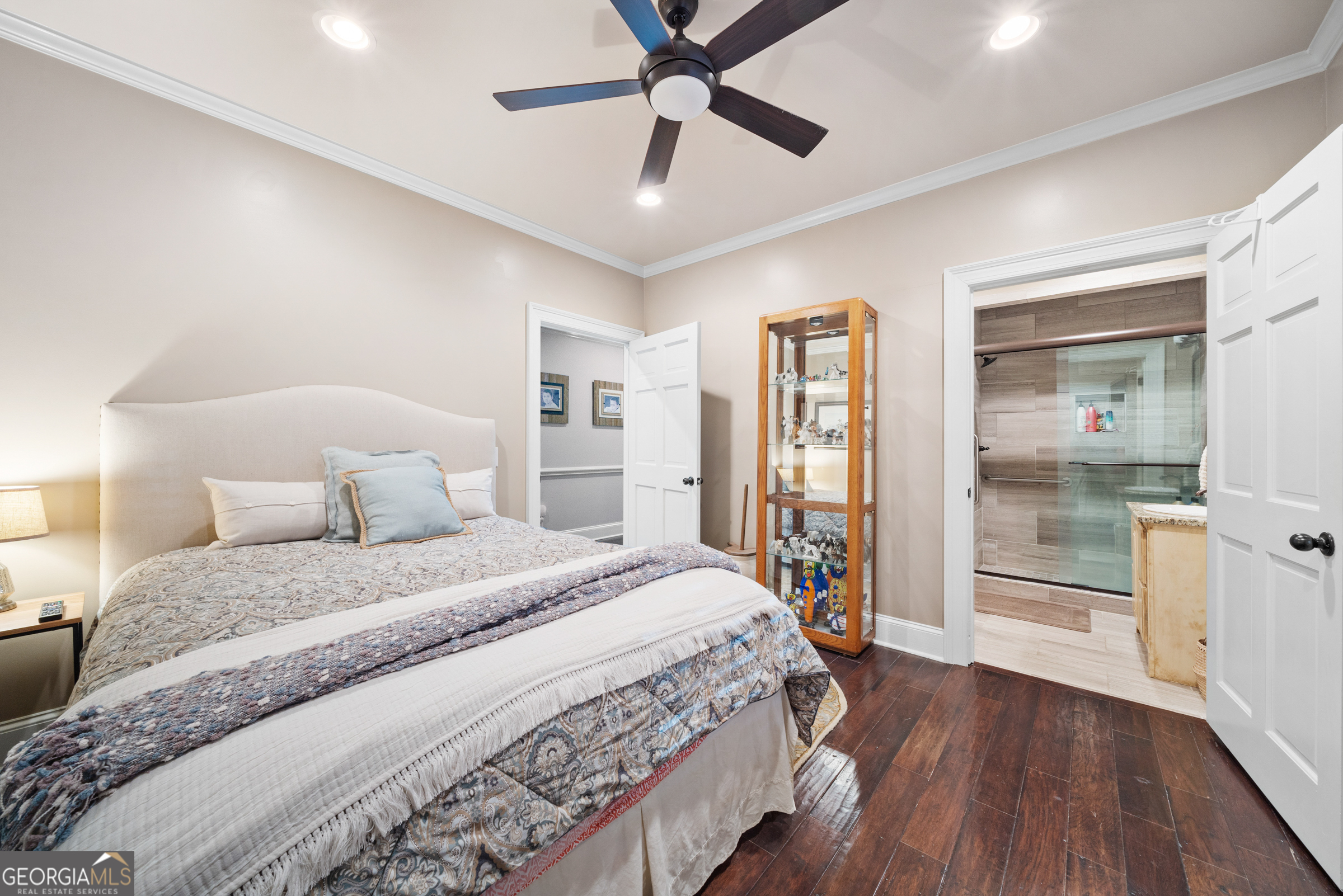 121 Grace Trace Lizella, GA 31052 - Photo 76 of 197 a bedroom with a large bed and a chandelier