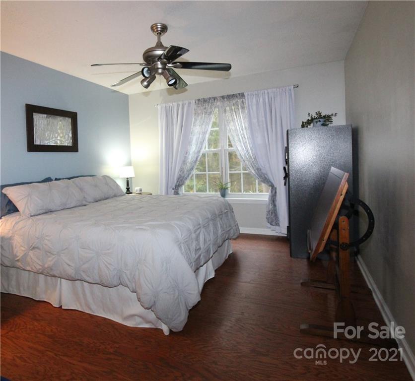 1900 Mt Pleasant Road North Concord, NC 28025 - Photo 13 of 21 a bedroom with a bed and a chandelier