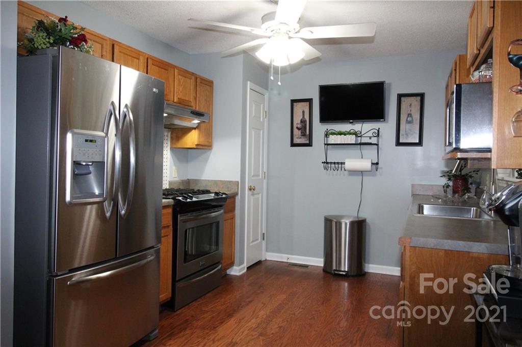 1900 Mt Pleasant Road North Concord, NC 28025 - Photo 9 of 21 a kitchen with stainless steel appliances a refrigerator stove and microwave