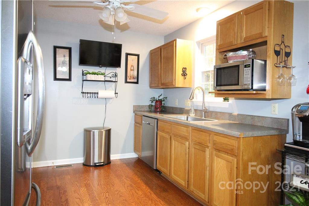 1900 Mt Pleasant Road North Concord, NC 28025 - Photo 10 of 21 a kitchen with stainless steel appliances granite countertop a sink microwave and refrigerator