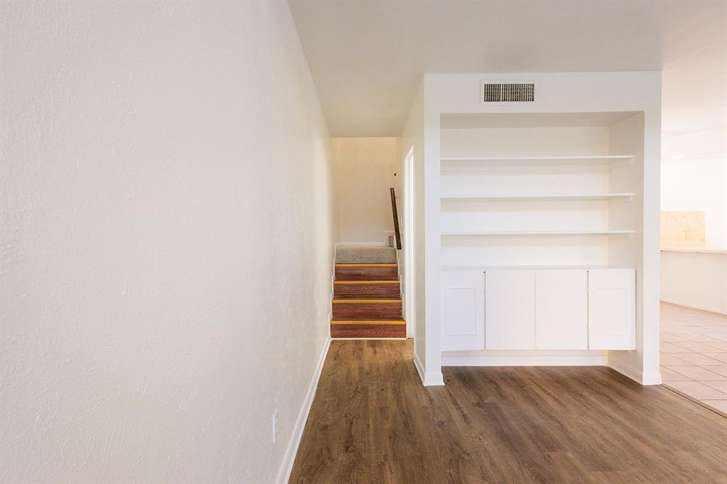 5540 Boca Raton Boulevard, Unit 175 Fort Worth, TX 76112 - Photo 14 of 30 Stairway with wood finished floors and baseboards