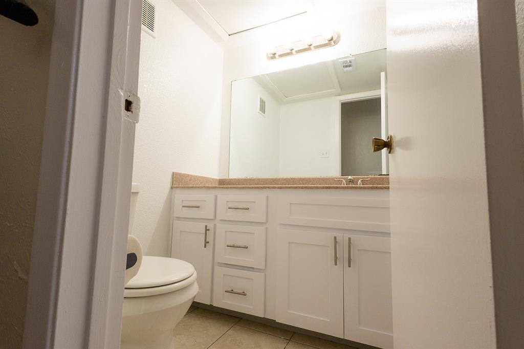 5540 Boca Raton Boulevard, Unit 175 Fort Worth, TX 76112 - Photo 16 of 30 Half bath featuring light tile patterned floors and vanity