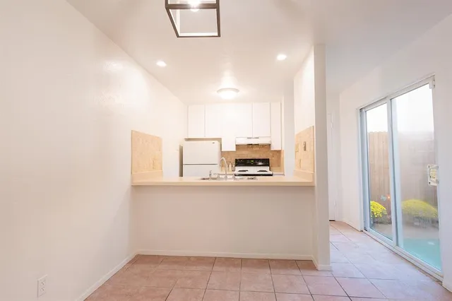 a kitchen with stainless steel appliances a refrigerator and a stove