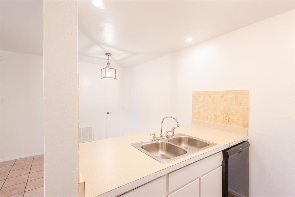 5540 Boca Raton Boulevard, Unit 175 Fort Worth, TX 76112 - Photo 9 of 30 Kitchen with light countertops, white cabinetry, dishwasher, light tile patterned flooring, and decorative light fixtures