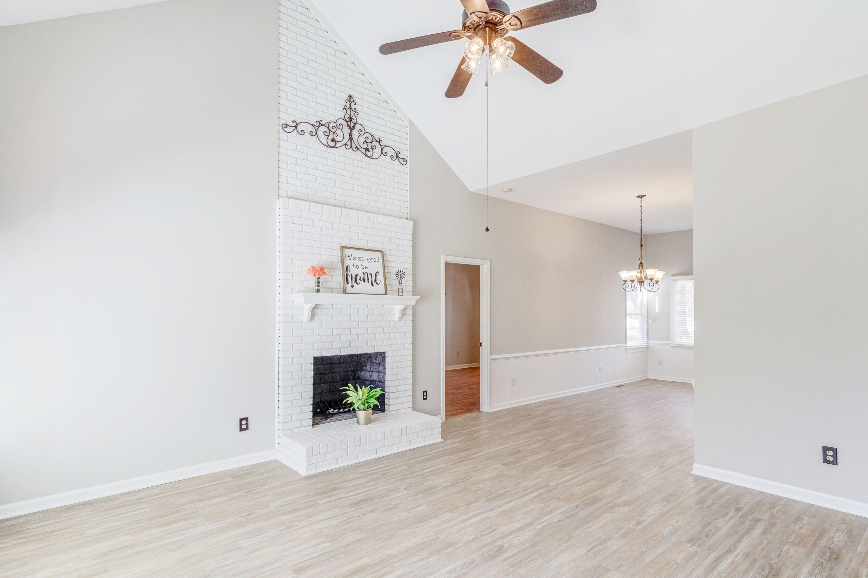 9305 Tallgrass Road Raleigh, NC 27603 - Photo 1 of 49 Spacious Family room w/cathedral ceiling, updated lighting, new LVP flooring, floor to ceiling masonry fireplace, and huge triple window with paladium! Family Room