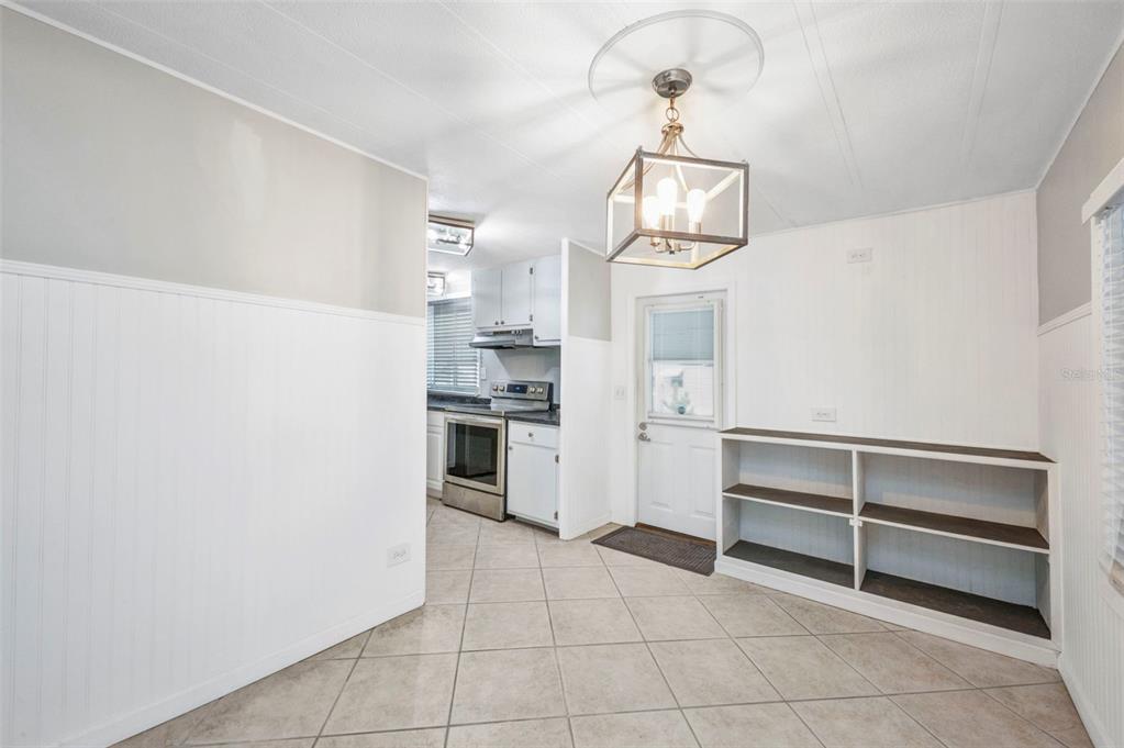 10100 Burnt Store Road, Unit 21 Punta Gorda, FL 33950 - Photo 11 of 61 a view of a kitchen with wooden cabinet and stainless steel appliances