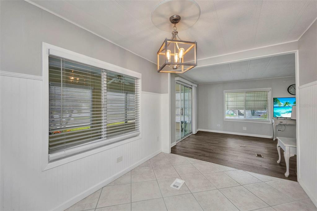 10100 Burnt Store Road, Unit 21 Punta Gorda, FL 33950 - Photo 13 of 61 a view of an empty room with a window and chandelier