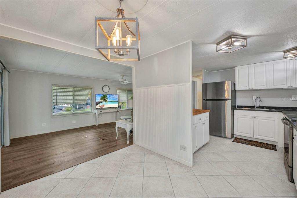 10100 Burnt Store Road, Unit 21 Punta Gorda, FL 33950 - Photo 14 of 61 a kitchen with stainless steel appliances granite countertop a refrigerator and a stove top oven