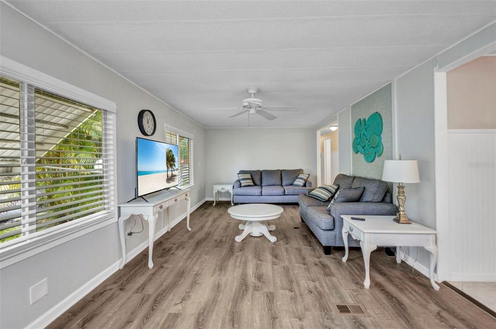 10100 Burnt Store Road, Unit 21 Punta Gorda, FL 33950 - Photo 16 of 61 a living room with furniture and a flat screen tv