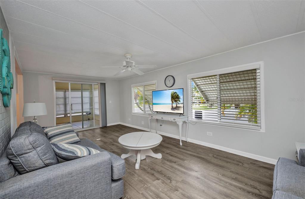 10100 Burnt Store Road, Unit 21 Punta Gorda, FL 33950 - Photo 17 of 61 a living room with furniture a window and a table