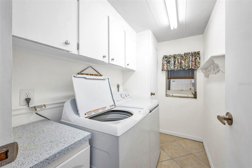 10100 Burnt Store Road, Unit 21 Punta Gorda, FL 33950 - Photo 19 of 61 a utility room with cabinets washer and dryer