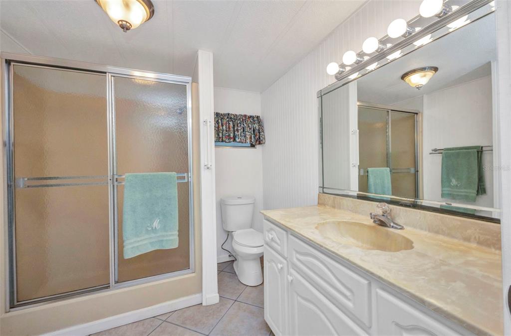 10100 Burnt Store Road, Unit 21 Punta Gorda, FL 33950 - Photo 21 of 61 a bathroom with a granite countertop sink toilet and shower