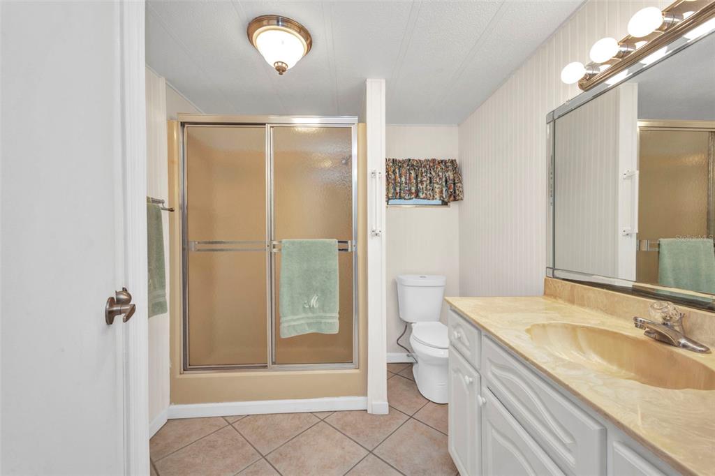 10100 Burnt Store Road, Unit 21 Punta Gorda, FL 33950 - Photo 22 of 61 a bathroom with a granite countertop sink toilet and shower