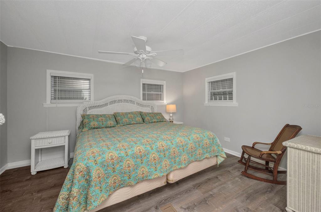10100 Burnt Store Road, Unit 21 Punta Gorda, FL 33950 - Photo 23 of 61 a bedroom with a bed and wooden floor