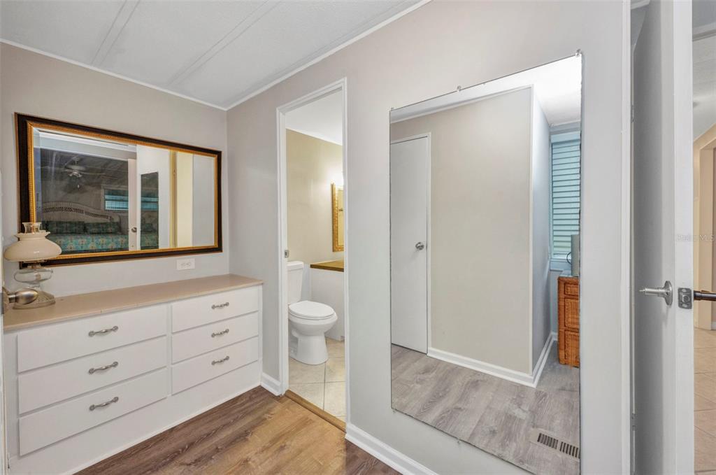 10100 Burnt Store Road, Unit 21 Punta Gorda, FL 33950 - Photo 25 of 61 a bathroom with a toilet a sink and a mirror