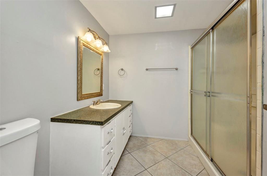 10100 Burnt Store Road, Unit 21 Punta Gorda, FL 33950 - Photo 26 of 61 a bathroom with a granite countertop sink and a mirror