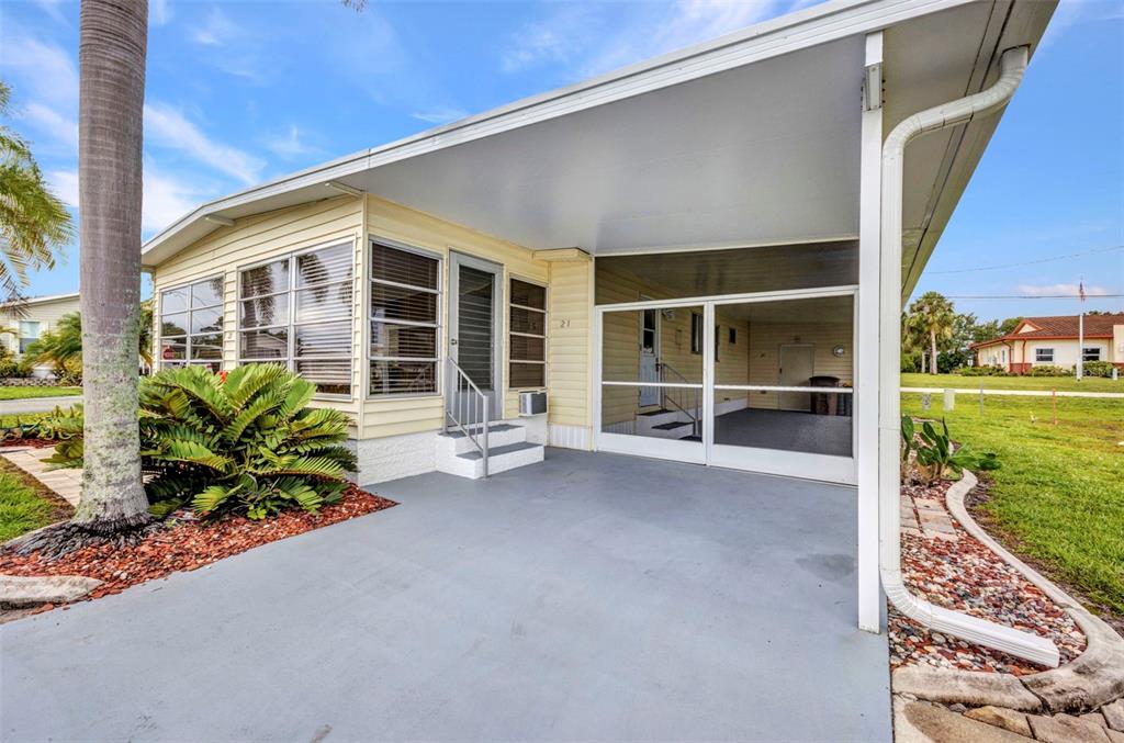 10100 Burnt Store Road, Unit 21 Punta Gorda, FL 33950 - Photo 4 of 61 a view of a house with a porch and garden
